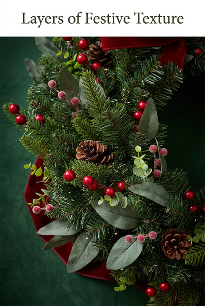 Close-up of layered greenery with pinecones and red and pink berries