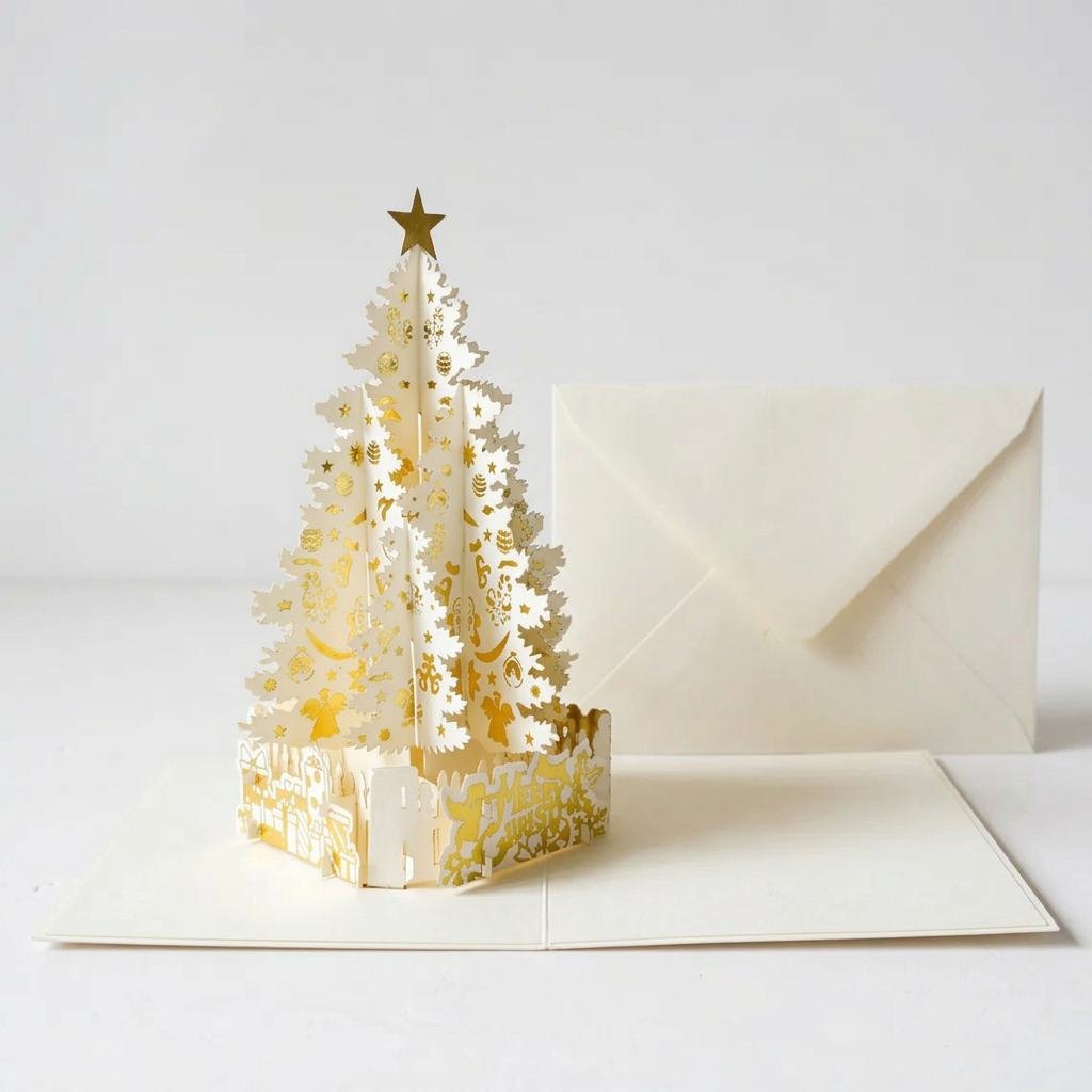 Ivory and gold pop-up Christmas tree card and plain envelope on white background