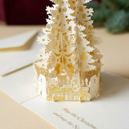 Cut-paper gift details surrounding the base of the Christmas tree