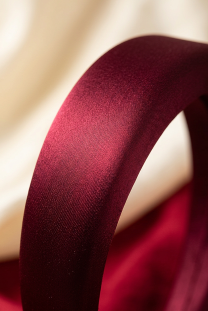 Close-up of the burgundy headband fabric surface and curved crown